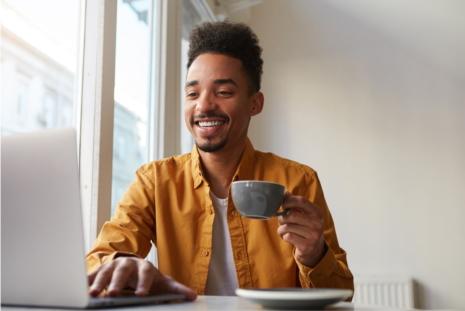 african-american-sitting-table-cafe-working-laptop-wears-yellow-shirt-drinks-aromatic-coffee-communicates-with-his-sister-which-is-far-another-country-enjoys-work-2 african-american-sitting-table-cafe-working-laptop-wears-yellow-shirt-drinks-aromatic-coffee-communicates-with-his-sister-which-is-far-another-country-enjoys-work-2